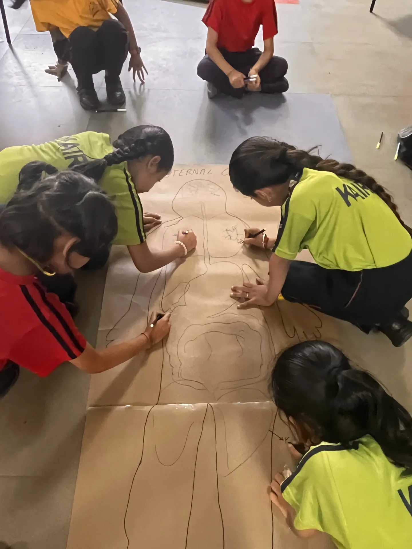 Students drawing human anatomy during a creative studio activity at Manaskriti School Faridabad