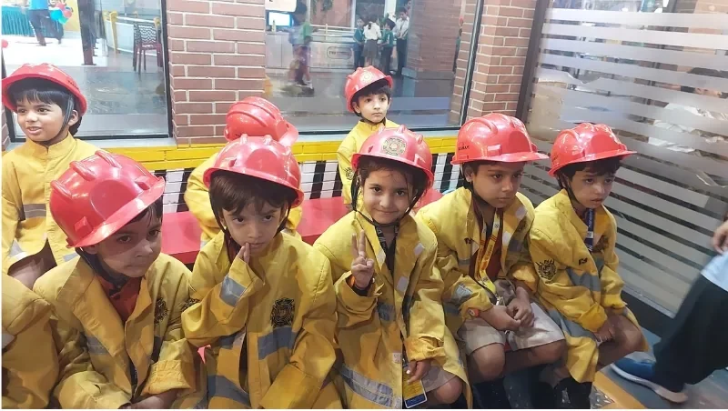 Students learning through firefighter role play at Manaskriti School Faridabad