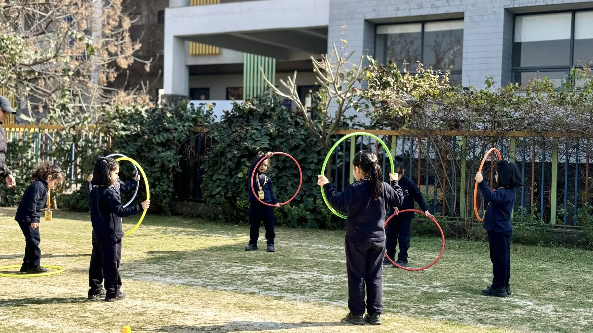 Early years students playing with hula hoops at Manaskriti School Faridabad