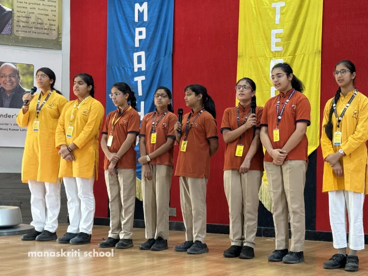 Students performing on stage as part of the Aakar programme at Manaskriti School Faridabad