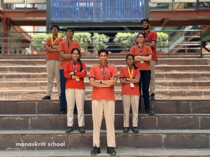 Senior students posing on the campus steps at Manaskriti School Faridabad